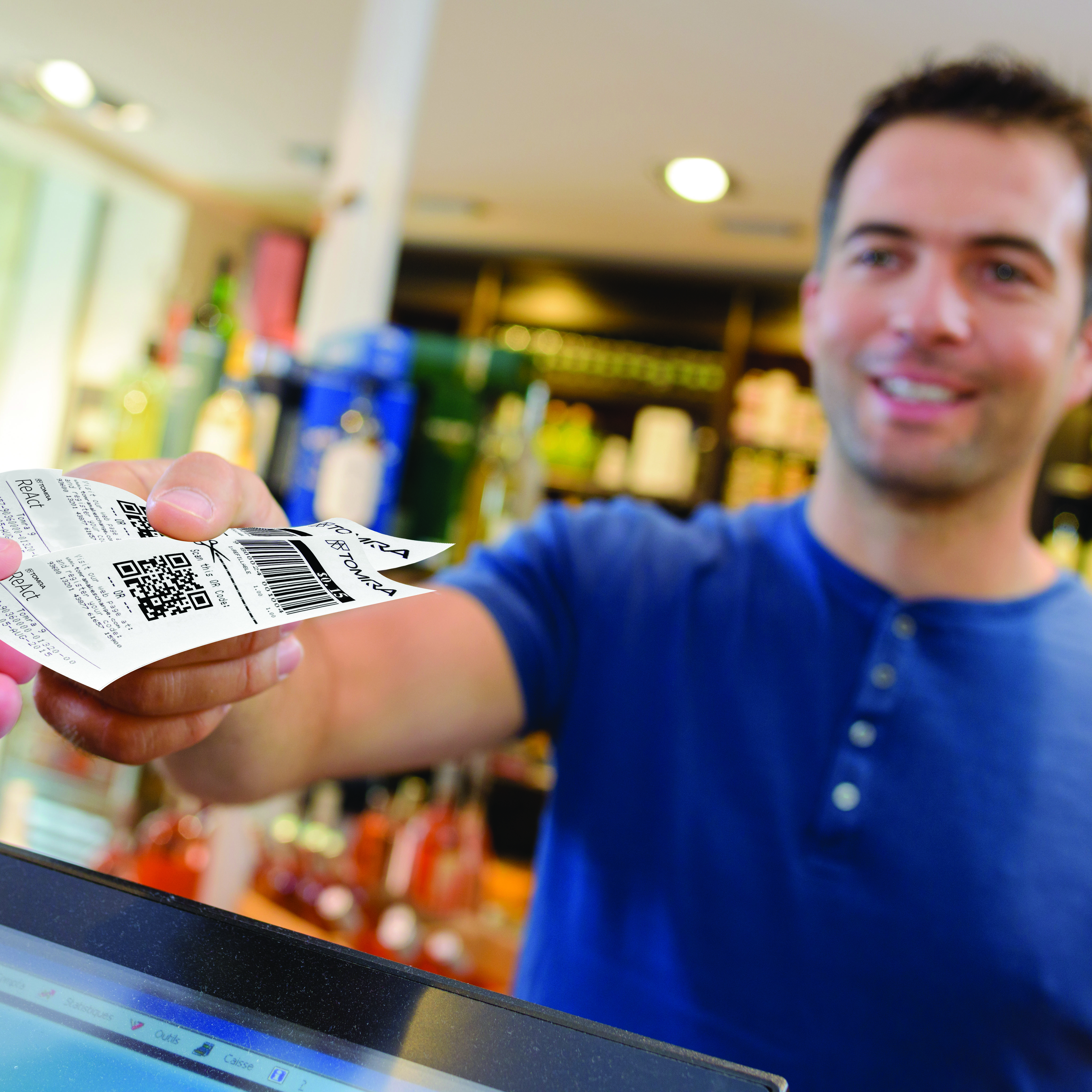 man paying for purchase in wine merchant